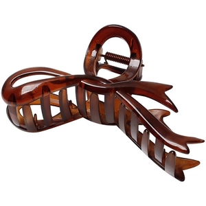 Large amber tortoiseshell claw clip for thick hair featuring a twisted ribbon design
