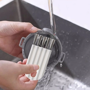 Flexible white cleaning brush for bottle caps and lid crevices under running water