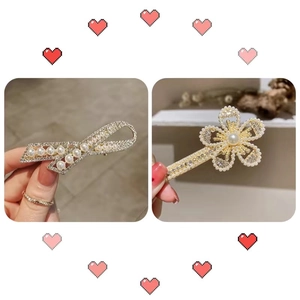 Detail of flower and bow hair clips with pearls and rhinestones on gold metal