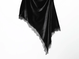 Nahaufnahme des schwarzen Satinkleids mit eleganten Spitzendetails auf weißem Grund