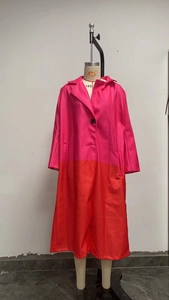 Detail of color-block wool coat showing notch lapel and single-breasted button closure