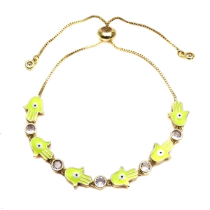 Adjustable golden Hamsa hand bracelet with green enamel and sparkling cubic zirconia detail