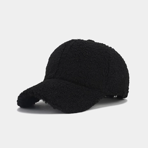 Macro detail of the fuzzy lamb wool texture on a black solid color baseball cap