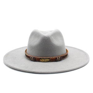 Detail of light gray wide-brim cowboy hat with woven band and golden feather buckle