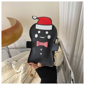 Close-up of gingerbread man chain bag with red Santa hat and pink bow decoration