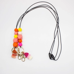 Detailed view of silicone beads lanyard with tassels and gold lobster clasp