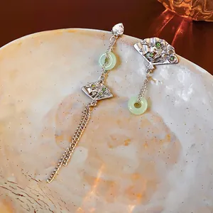 Silver-toned fan-shaped asymmetric fringe earrings with green resin jade and rhinestones
