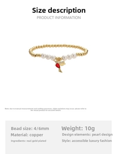 Detail of copper gold-plated bead bracelet with pearl accents and red bird charm