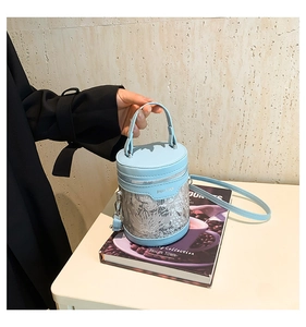 Detail of light blue PU leather bucket bag with lace embroidery and zip closure