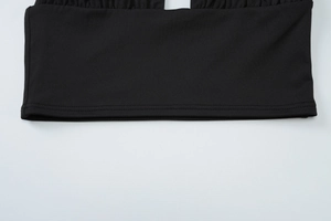 Detailed close-up showing the high-quality black knit fabric and precise stitching on the hem