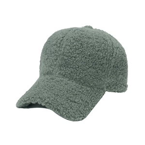 Detailed 45-degree side view of a sage green plush faux lamb wool baseball cap
