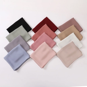 Chiffon silk headscarf collection in diverse solid colors neatly arranged on a white background