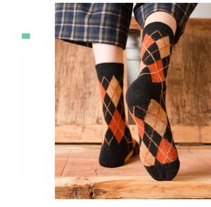 Detailed argyle knit texture and ribbed cuff of these vintage warm wool socks for women