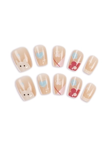 Detail view of cartoon animal press-on nails with rabbit, heart and flower designs