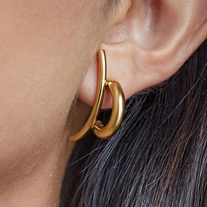 Elegant gold curved stud earrings for women in polished stainless steel on model
