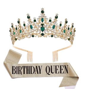 Detail view of golden crystal crown with green gems and Birthday Queen glitter sash