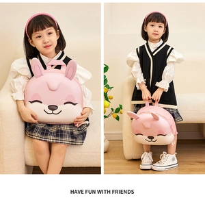 Pink EVA 3D rabbit ear schoolbag shown on a child model in a cozy indoor setting