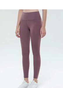 Macro shot of high-waist mauve yoga pants showing brushed matte texture and seamless seams