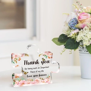 Detailed view of puzzle-shaped acrylic plaque with pink roses and thank you message