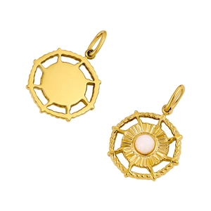 Detail view of round gold pendant with sunburst design and white opal stone inlay