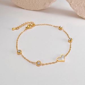 Elegant gold titanium bracelet with white shell heart pendant and sparkling zircons
