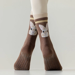 Detail of coffee-colored cotton yoga socks with rabbit pattern and anti-slip silicone dots