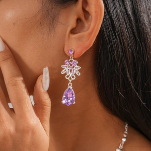 Detailed view of elegant purple teardrop earrings with silver hollow flower design