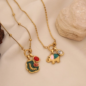 Vintage gold necklaces with elephant and caterpillar enamel pendants and stones