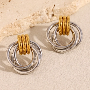 Détail d'anneaux dorés et argentés entrelacés montrant l'effet de couche des boucles d'oreilles