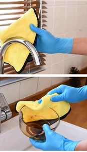Blue nitrile gloves and yellow microfiber cloth used for cleaning faucet and shutters