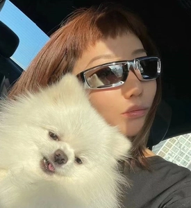 Close-up of silver Y2K futuristic punk sunglasses with black lenses in a car setting