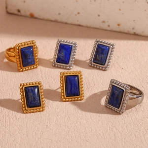 Detailed close-up of 18K gold and silver retro lapis lazuli rings and earrings set