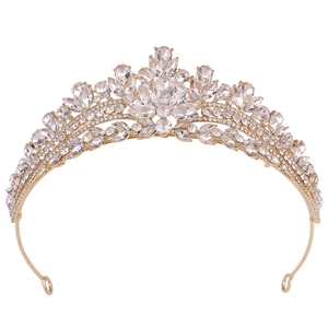 Close-up of a gold bridal tiara crown with intricate rhinestones and sparkling crystals