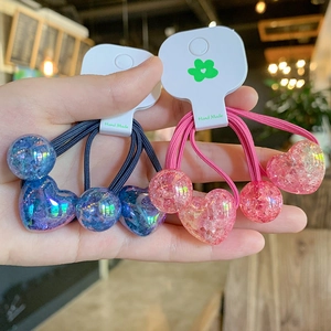 Detail of pink and blue resin heart hair ties with glitter fragments and elastic cord