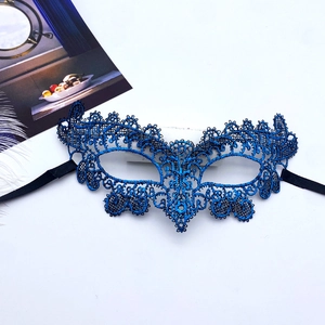 Detailed top view of a dark blue lace masquerade mask with intricate hollow patterns