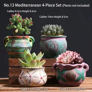 Detailed view of four Mediterranean style ceramic succulent pots with retro hand-painted patterns