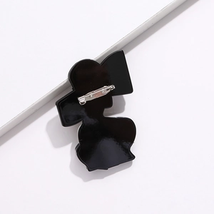 Black acrylic lady silhouette brooch with metal pin on minimalist white background