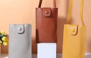 Close-up of minimalist phone crossbody bags with litchi grain leather and snap closure