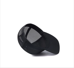 Detail view of black mesh truck hat showing breathable fabric and plastic snapback closure