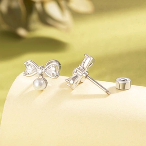 Elegant silver bow pearl earrings with crystal details and screw back titanium steel studs