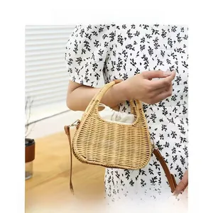 Detailed macro view of woven straw handbag with drawstring lining and leather shoulder strap