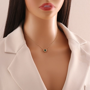 Elegant gold heart pendant necklace with deep green gemstone on a model neck