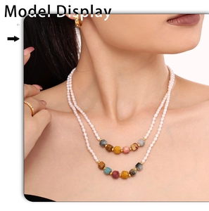 Detail of layered handmade necklace with natural stones and freshwater pearls on model