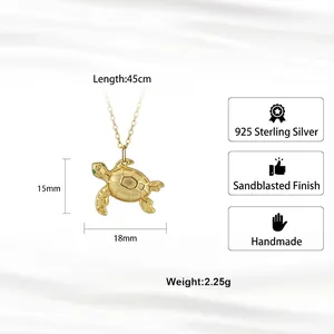 Gold-plated 925 sterling silver sea turtle necklace with sandblasted finish and green eyes