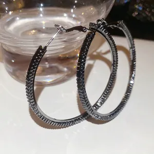 Luxe pave-set black zircon hoop earrings crafted in gunmetal finish for a modern look