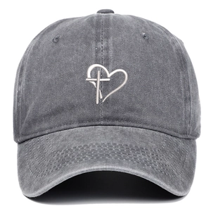 Detailed close-up of cross and heart embroidery on a gray washed cotton baseball cap