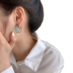 Transparent green jelly hoop earrings worn by a model for a stylish minimalist look