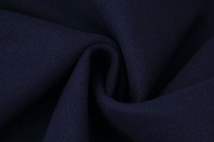 Detailed macro view showing the thick navy blue wool blend fabric texture and soft fiber surface