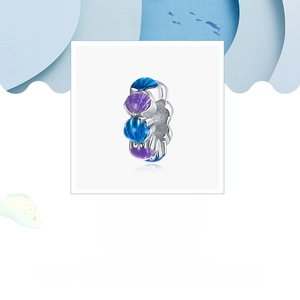 Macro detail of S925 sterling silver shell bead with blue and purple enamel craft