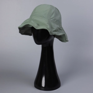Light green wide brim sun bucket hat for women on model, minimalist breathable design